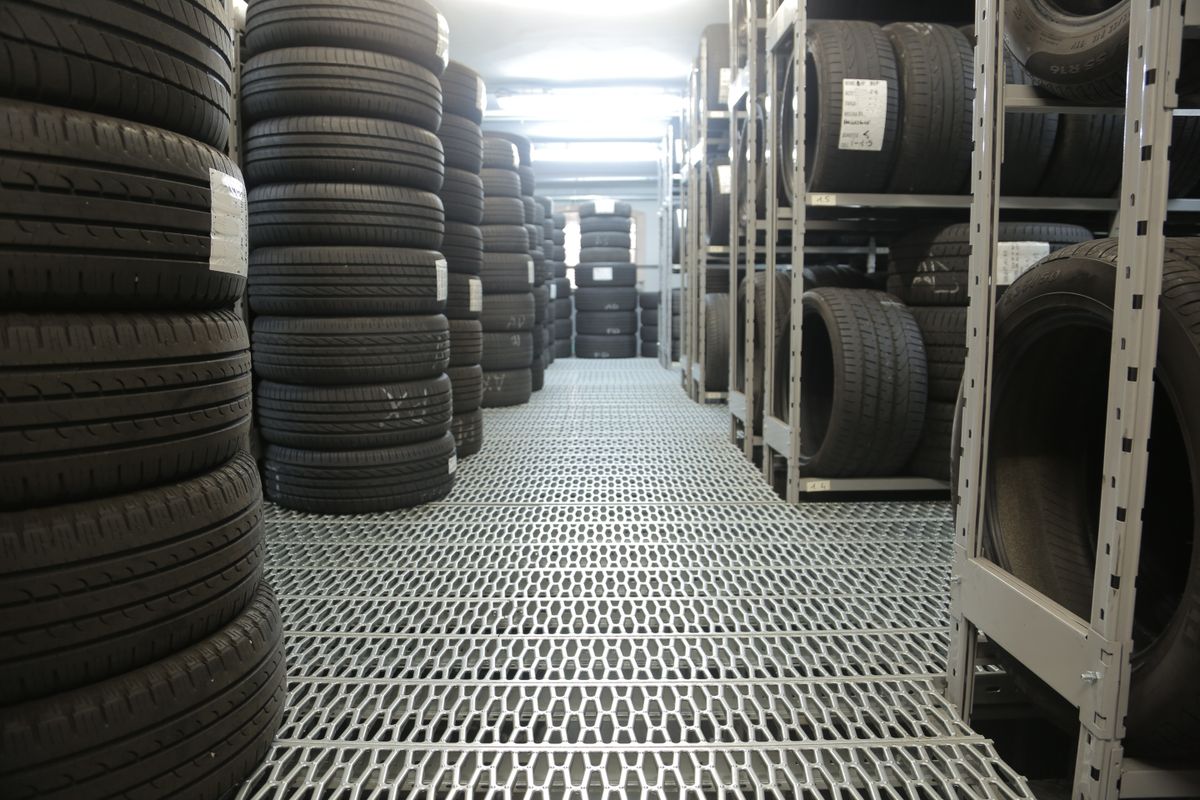 Rows of black tires with detailed tread patterns
